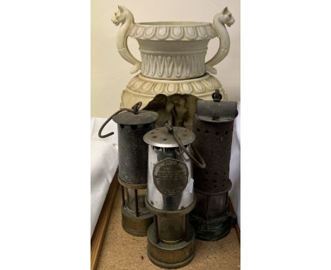 Three steel and brass miners lamps together with a resin light in the form of a Roman lamp