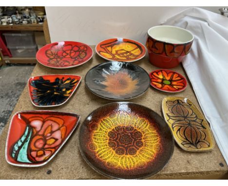 A collection of Poole pottery plates, bowl etc decorated in oranges, reds and browns