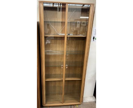 An Ercol light elm display cabinet with glazed doors and shelves, 92 wide x 214cm high 