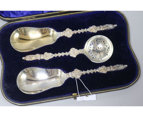 A Victorian cased pair of silver apostle serving spoons and matching sifter spoon by William Hutton & Sons, London, 1900, in 