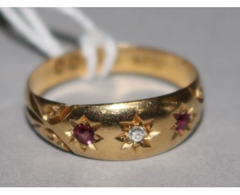 An early 20th century 18ct gold ruby and diamond gypsy set ring, size R.