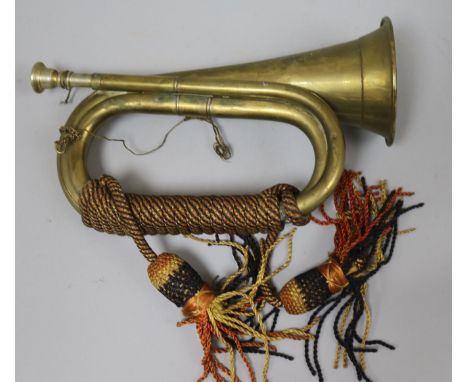 A brass bugle, a cast iron lion and various candlesticks