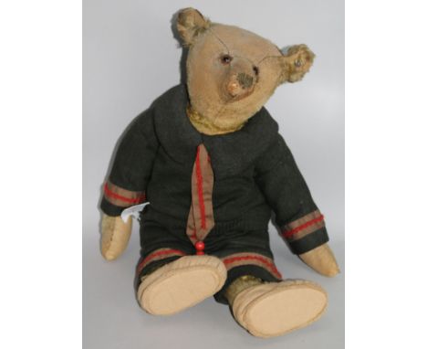 A 1920's Steiff blonde mohair teddy bear with glass eyes, Steiff ear stud, wearing a German naval uniformThe late owner was b