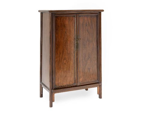 A Chinese Elmwood Sloping-Style Cupboard, late 19th century, the moulded top inset with a rectangular panel above single-pane