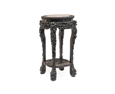 A Chinese Carved Padouk Wood and Pink Marble Plant Stand, early 20th century, the inset marble top within a flower-carved and