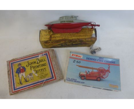 A boxed 'Unda-Wunda' diving submarine, a boxed John Bull Printing Outfit and a Keilkraft 1914 Dennis Fire Engine kit.
