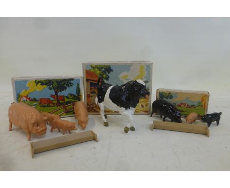 A boxed Britains farm animals set, one bull walking no. 5004, a boxed set no. 5024 containing two pigs, two piglets and a tro