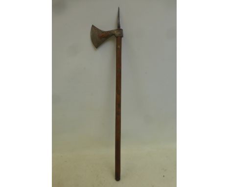 Possibly an Indian war axe, having copper figures overlaid on the steel head and mounted on a wooden shaft with brass decorat