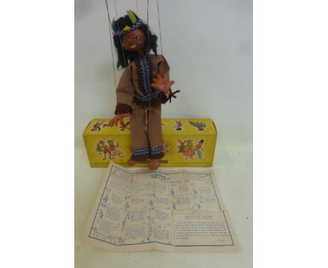 A boxed Pelham Puppet, depicting a Native American, with original felt feathers. 