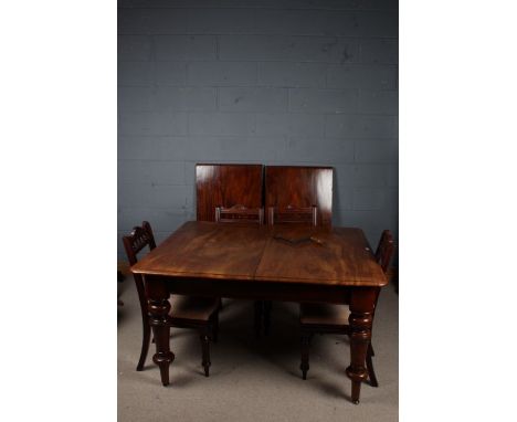 Victorian mahogany extending dining table, the rectangular top with rounded corners raised on baluster legs, with two leaves,