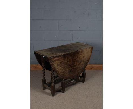 18th century oak gate leg table, the rectangular top with two drop leaves with a single draw, raised on barley twist legs and