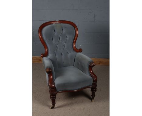 Victorian mahogany nursing chair, upholstered in blue with a button back raised on turned legs with castors, 107cm high