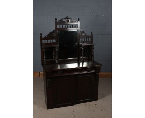 Late Victorian mirror backed chiffonier, with a swan neck pediment, the cupboard doors opening to reveal a single shelf, 102c