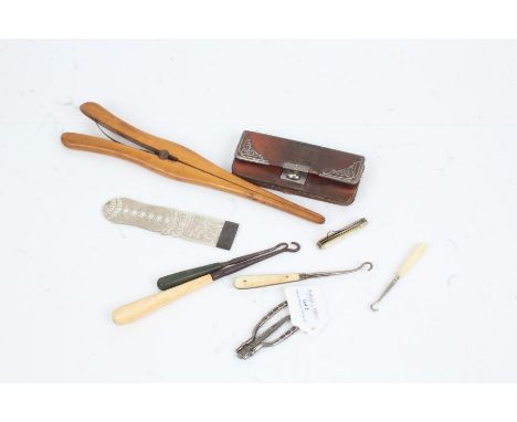 Small silver mounted leather purse, collection of button hooks, glove stretcher (qty)