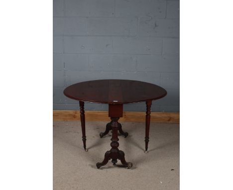 Victorian mahogany sutherland table, with rounded leaves and raised on scrolling legs with carved acanthus leaf decoration, 1