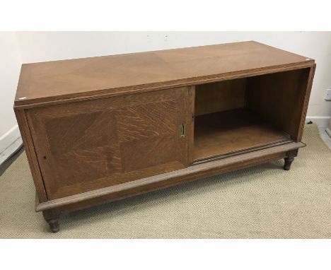 A mid 20th Century oak side cabinet formerly from a French haberdashery, the quartered and cross-banded top over two sliding 