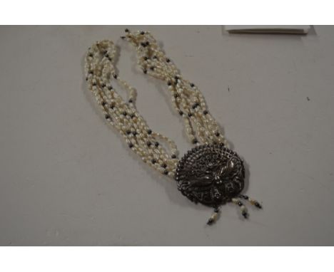 A plaited six strand fresh water pearl and Hematite bead choker, with a silver butterfly motif pendant approx 16" long, and a