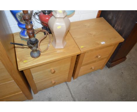 A pair of light oak two drawer bedside chests
