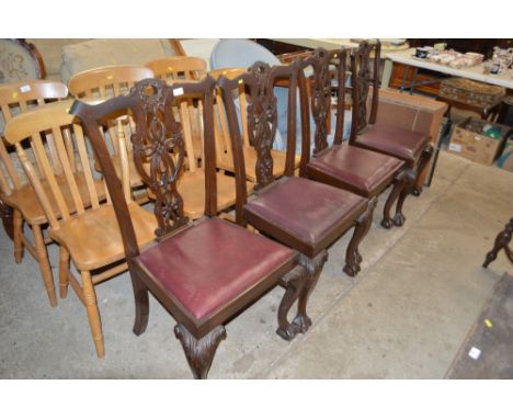 A set of four Chippendale style dining chairs, raised on claw and ball supports