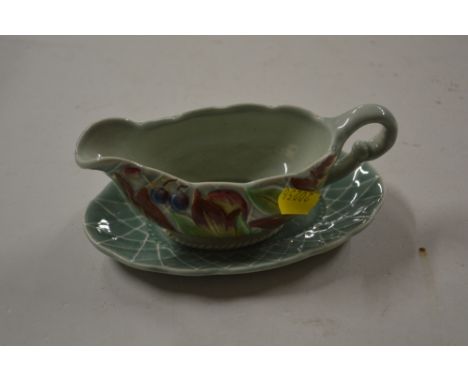 A Clarice Cliff floral decorated sauce boat on stand 