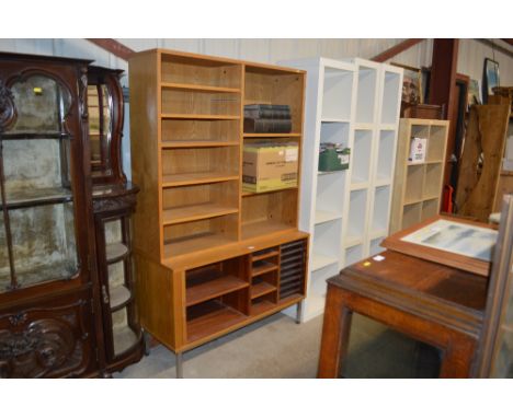 A light oak veneered bookcase raised on tambour fronted base