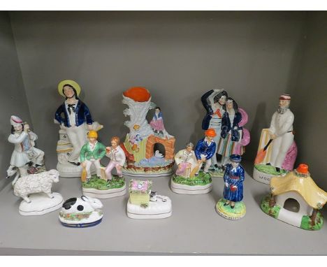 A group of Victorian Staffordshire and later figurines and model animals to include one of W G Grace