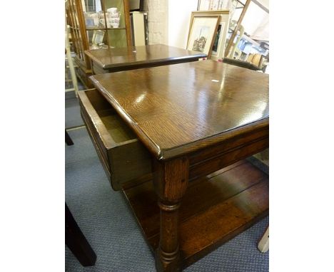 A pair of Titchmarsh and Goodwin style oak lamp tables with a drawer on turned block legs