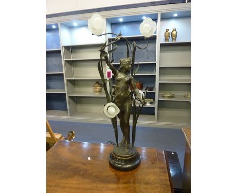 Circa 1900, an Art Nouveau spelter four-branch lamp, central figure depicting a naked female flanked by flora, standing on a 