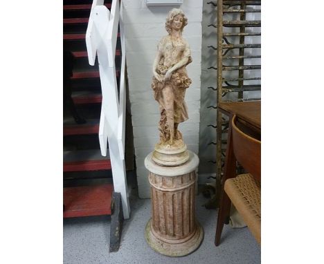 A smaller pair of composition stone garden statues on pedestal bases