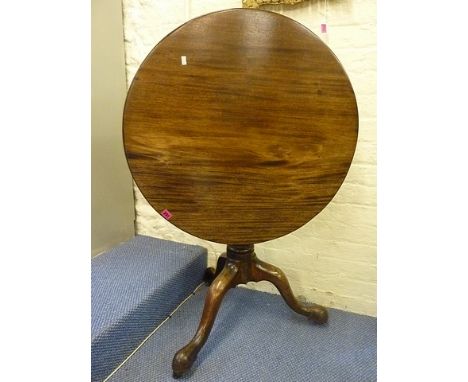 A George III mahogany tilt top table with a turned column on a tripod base