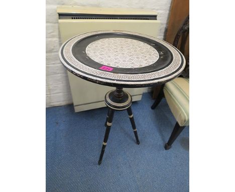 An early 20th century Asian mother of pearl and bone inlaid black painted wooden table with a dished top over a turned column