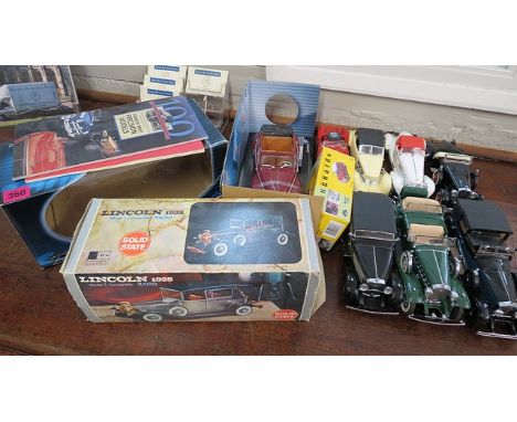 A collection of model vehicles to include a Franklin Mint 1935 Auburn Boattail Speedster