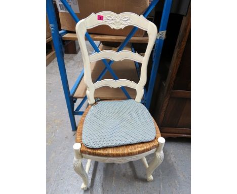 A set of ten early 20th century French, white painted ladder back, rush seated chairs