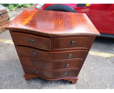 A pair of reproduction mahogany serpentine fronted chest of two short and three long drawers on bracket feet