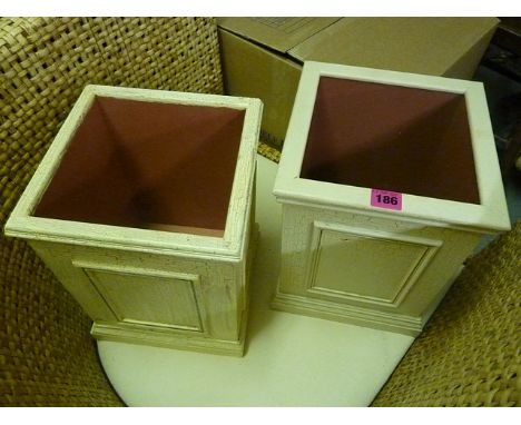 A pair of cream painted ceramic planters