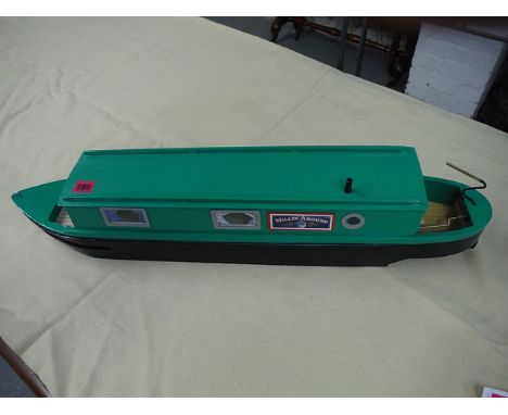 A scratch built green painted, radio controlled model narrow boat, 30 long