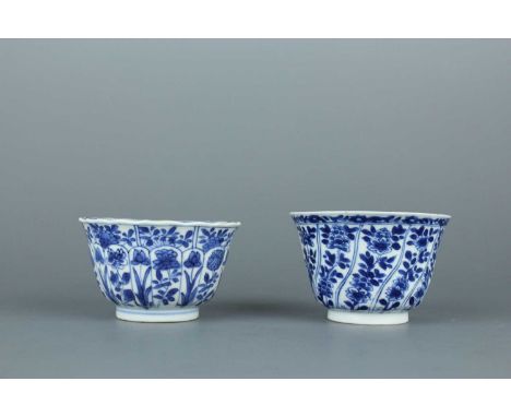 A near pair of Chinese blue and white cups, Kangxi period (1662–1722), Qing Dynasty.  Each vibrantly painted with flowering b