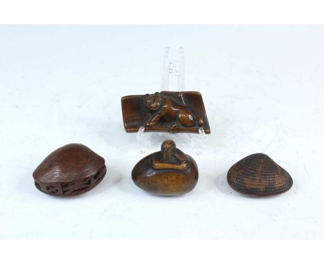 A Japanese wood netsuke in the form of a bamboo armrest with a crouching tiger inside, Edo period, 18th/19th century, diamete