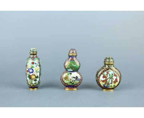 A set of three Chinese cloisonné enamel ‘birds and flowers’ snuff bottles, Qing Dynasty, 19th century, the first of elongated