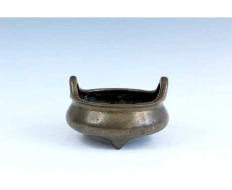 A Chinese wire inlaid bronze censer, 18th to 19th century, decorated on the body with stylised dragon among swirling clouds a