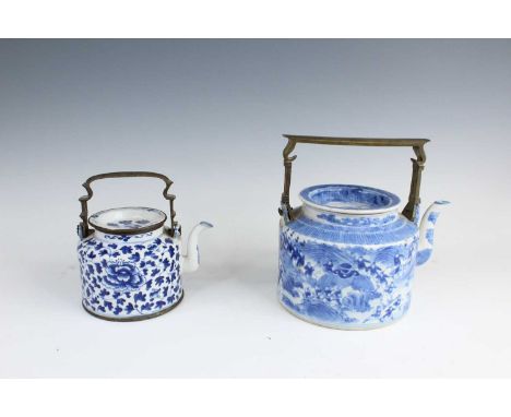 Two Chinese blue and white teapots with overhead metal handles, Qing Dynasty, late 19th century. One teapot of larger size is
