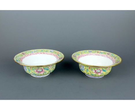 A pair of Chinese Canton yellow-ground enamel floral bowls, early 20th century. With a richly decorated wide mouth rim and a 