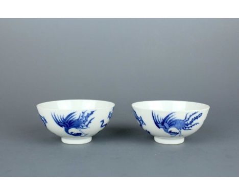 A pair of small Chinese blue and white “dragon and phoenix” bowls, Republican period. Each finely painted with two pairs of d