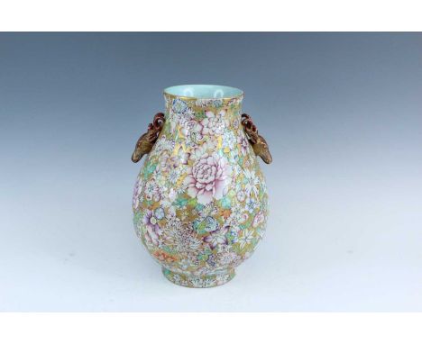 A Chinese gilt-ground famille rose millefleurs deer-head handled Hu vase, 20th century, decorated with two deer head handles 