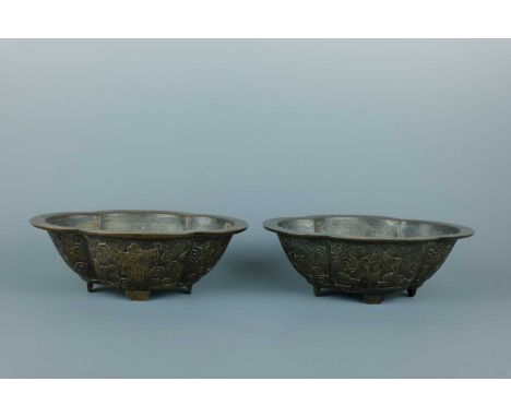 A pair of Chinese bronze quatrefoil-shaped ’Eight Immortals’ planters, QING DYNASTY 18th/19th century, each carved on the out