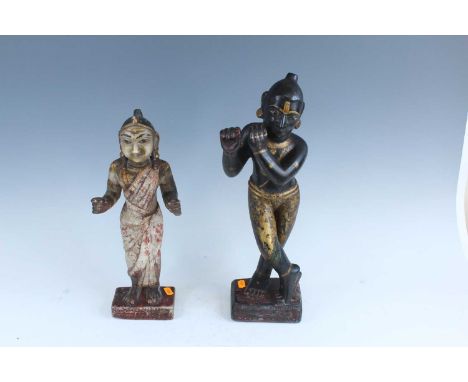 Two Indian stone-carved figures, 19th or 20th century, one depicting the Hindu deity Krishna in the posture of playing the fl