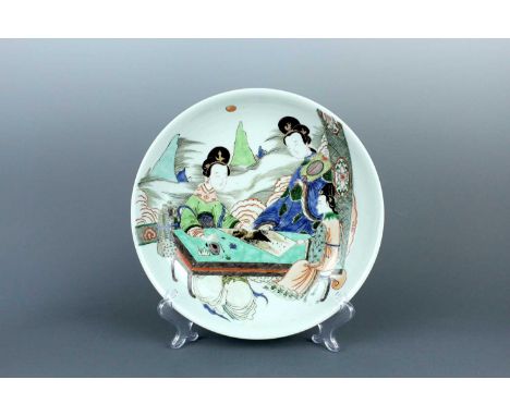 A large Chinese famille verte ‘ladies’ dish, in Kangxi-style but later. Finely depicted with a courtly scene of three elegant