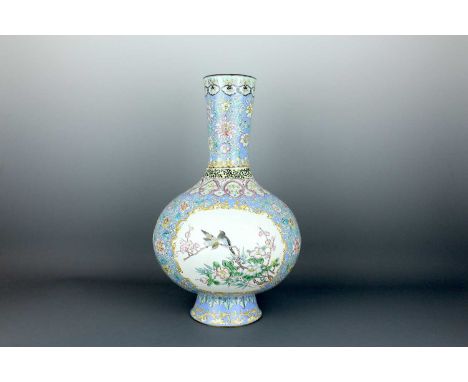 A large Chinese Canton enamel bottle vase, Qing Dynasty 19th century. The globular body rests on a splayed foot and supports 