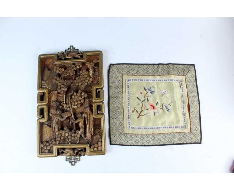 A Chinese gilded carved wood panel and an embroidered handkerchief, Republican period. The panel carved and gilt with a figur