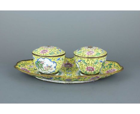 A set of Chinese Canton yellow-ground enamel covered bowls with a matching tray, Qing Dynasty, 19th Century. Painted all over